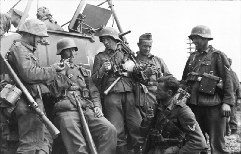 Archival photograph of German infantry resting beside an armoured half-track in the southern Soviet Union, 1942